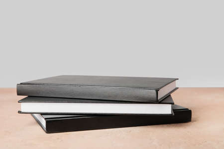 Stack of books on table against gray background, closeupの写真素材