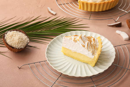 Plate with piece of tasty coconut pie on color backgroundの写真素材