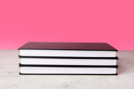 Stack of books on color backgroundの写真素材