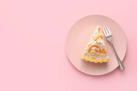 Plate with piece of tasty coconut pie on color backgroundの写真素材