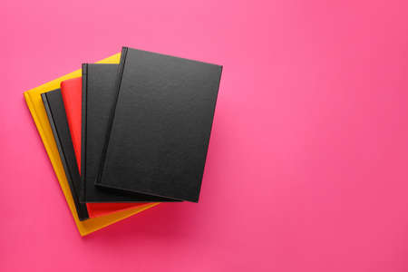 Stack of different books on color backgroundの写真素材