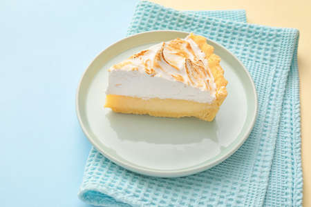 Plate with piece of tasty coconut pie on color backgroundの写真素材