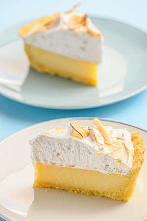 Plates with tasty coconut pie on color backgroundの写真素材