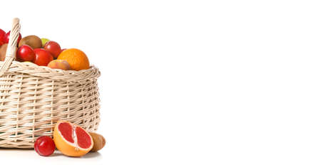 Basket with fresh fruits on white background with space for textの写真素材