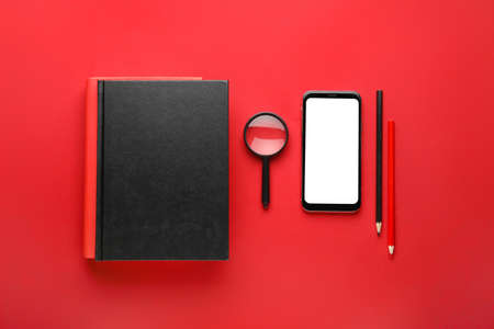 Composition with different books and mobile phone on color backgroundの写真素材