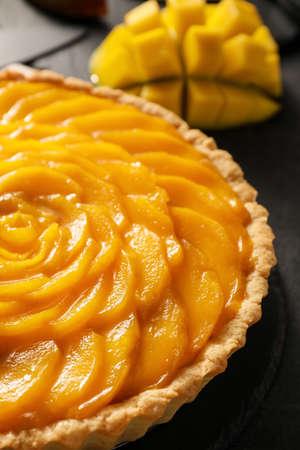 Tasty mango pie on dark backgroundの写真素材