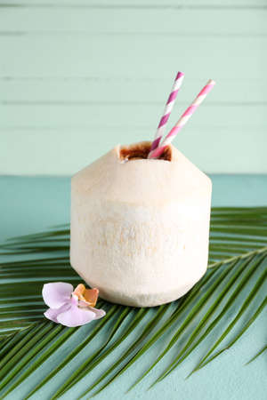Fresh coconut on color wooden backgroundの写真素材