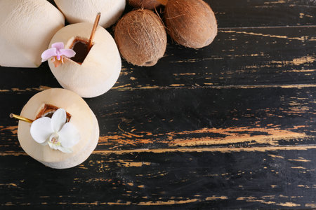 Fresh and ripe coconuts on dark wooden backgroundの写真素材
