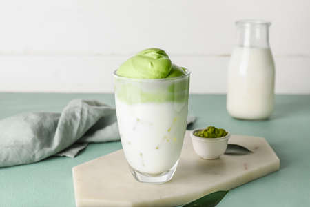Composition with tasty dalgona matcha latte on color backgroundの写真素材