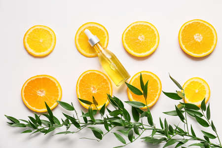 Bottle of orange essential oil on light background