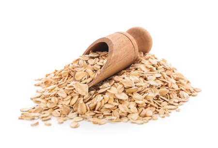 Scoop with raw oatmeal on white background