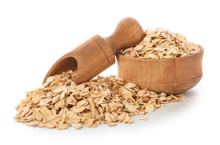 Bowl and scoop with raw oatmeal on white background