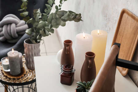 Table with burning candles in interior of room