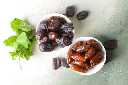 Bowls with sweet dates on tableの写真素材