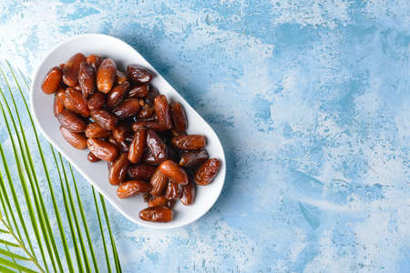 Plate with sweet dates on color backgroundの写真素材