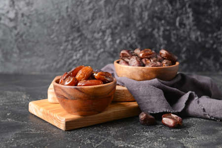 Bowls with sweet dates on dark backgroundの写真素材