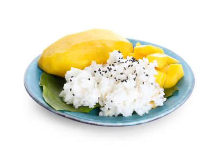 Plate with tasty rice and mango on white backgroundの写真素材