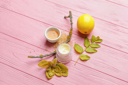 Composition with jar of natural cream on color wooden background
