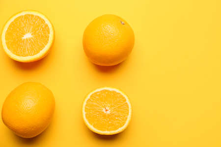 Fresh oranges on color background