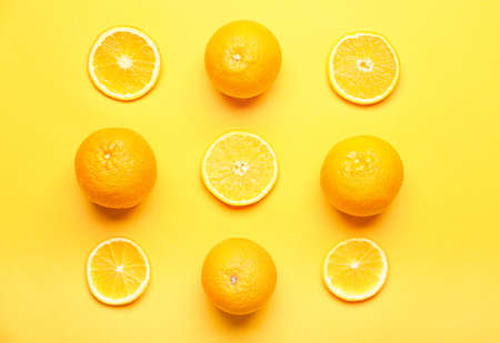 Fresh oranges on color backgroundの写真素材
