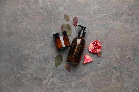 Composition with natural cosmetic products and pomegranate on dark backgroundの写真素材