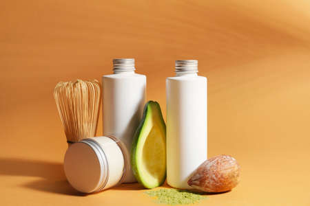 Composition with natural cosmetic products and avocado on color backgroundの写真素材