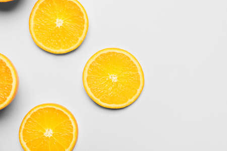 Pieces of fresh orange fruit on white backgroundの写真素材