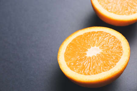 Piece of fresh orange on dark background