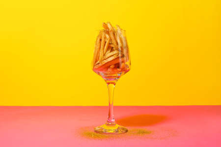 Creative composition with tasty french fries on color backgroundの写真素材