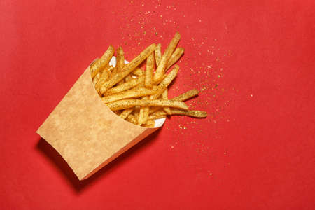 Glitters with tasty french fries on color backgroundの写真素材