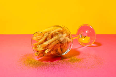 Creative composition with tasty french fries on color backgroundの写真素材