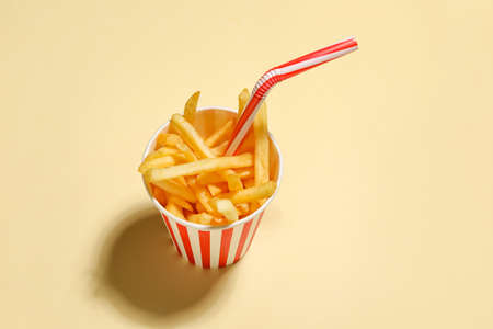 Creative composition with tasty french fries on color backgroundの写真素材