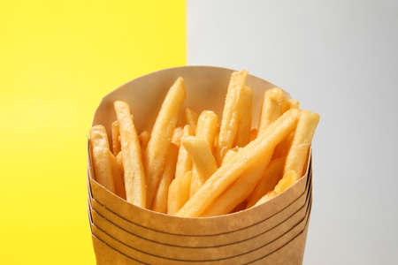 Boxes with tasty french fries on color backgroundの写真素材