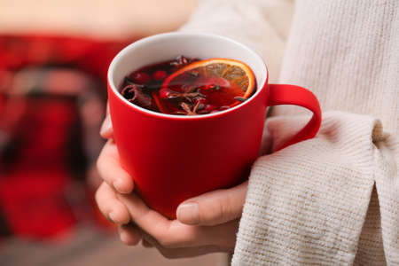 Woman drinking tasty mulled wine at home, closeupの写真素材