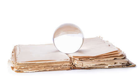 Crystal ball of fortune teller and spell book on white backgroundの写真素材