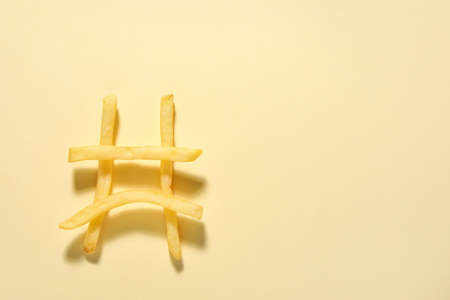 Creative composition with tasty french fries on color backgroundの写真素材