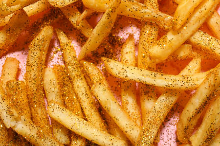 Glitters with tasty french fries on color background, closeup