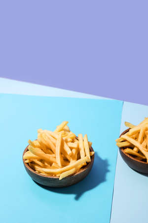 Bowls with tasty french fries on color backgroundの写真素材