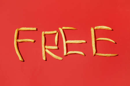Word FREE made of tasty french fries on color backgroundの写真素材