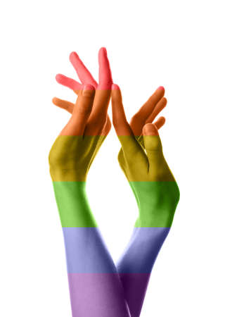 Female hands painted in colors of LGBT flag on white backgroundの写真素材