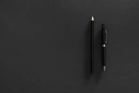 Pen and pencil on dark backgroundの写真素材