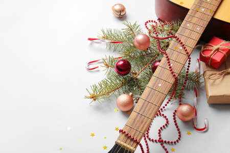 Guitar with Christmas decor on light backgroundの写真素材