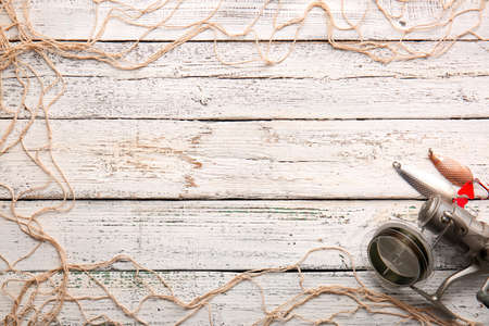 Frame made of fishing gear on wooden backgroundの写真素材