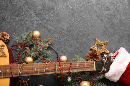 Guitar with Christmas decor on dark background