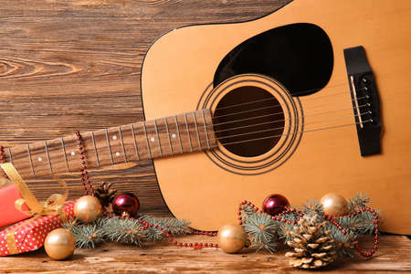 Guitar with Christmas decor on wooden backgroundの写真素材
