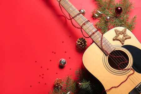 Guitar with Christmas decor on color backgroundの写真素材