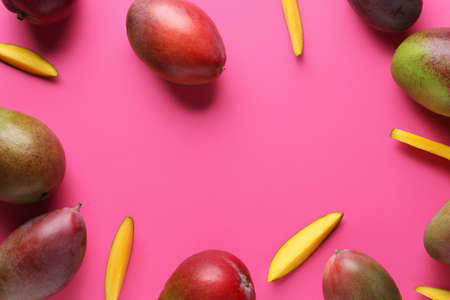 Frame made of sweet ripe mangoes on color backgroundの写真素材