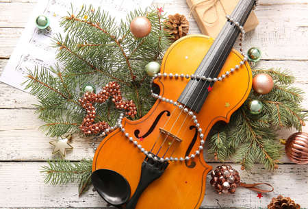 Violin and Christmas decor on white wooden backgroundの写真素材