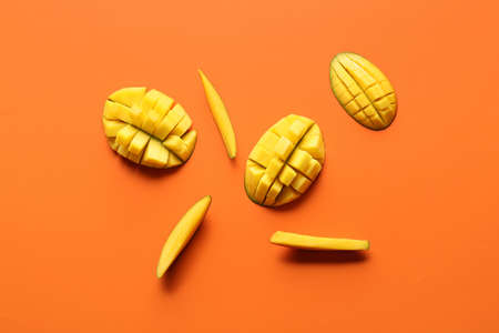 Sweet cut mangoes on color backgroundの写真素材