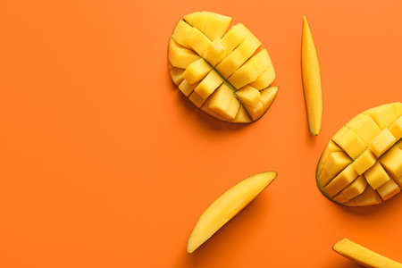 Sweet cut mangoes on color background